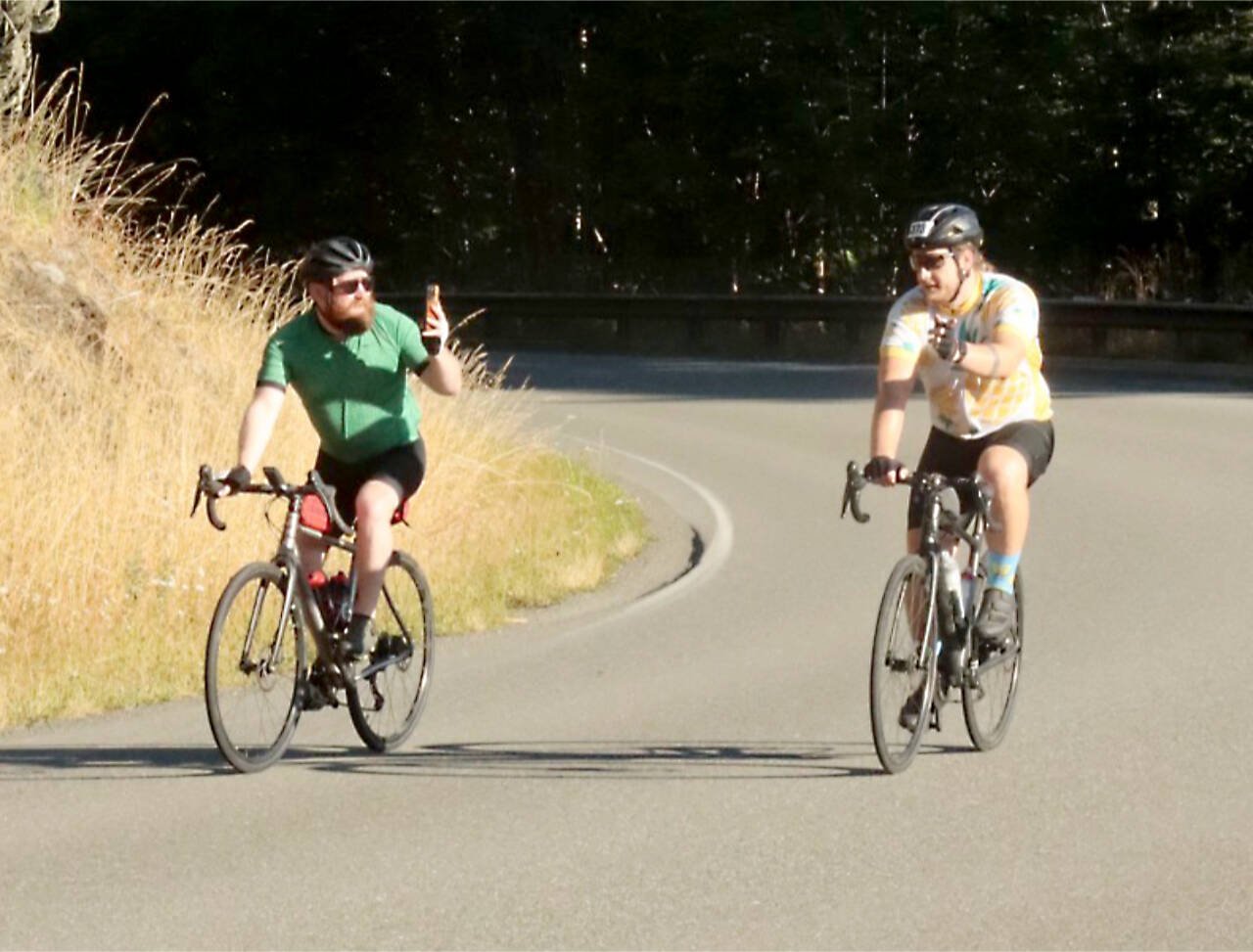 A cyclist takes a photo of his friend during the Ride the Hurricane up Hurricane Ridge Road on Sunday morning. More than 800 cyclists from Canada and the U.S. participated in this year's 17-mile-long ride. (Dave Logan/for Peninsula Daily News)