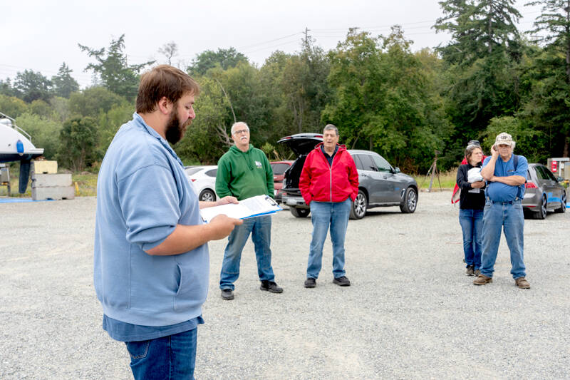 Port of Port Townsend Harbor Master Kristian Ferraro reads the protocol for bidding to interested parties attending the auction of the historic tug Elmore on Monday. The auction produced no bidders at the opening bid of $10,000. (Steve Mullensky/for Peninsula Daily News)