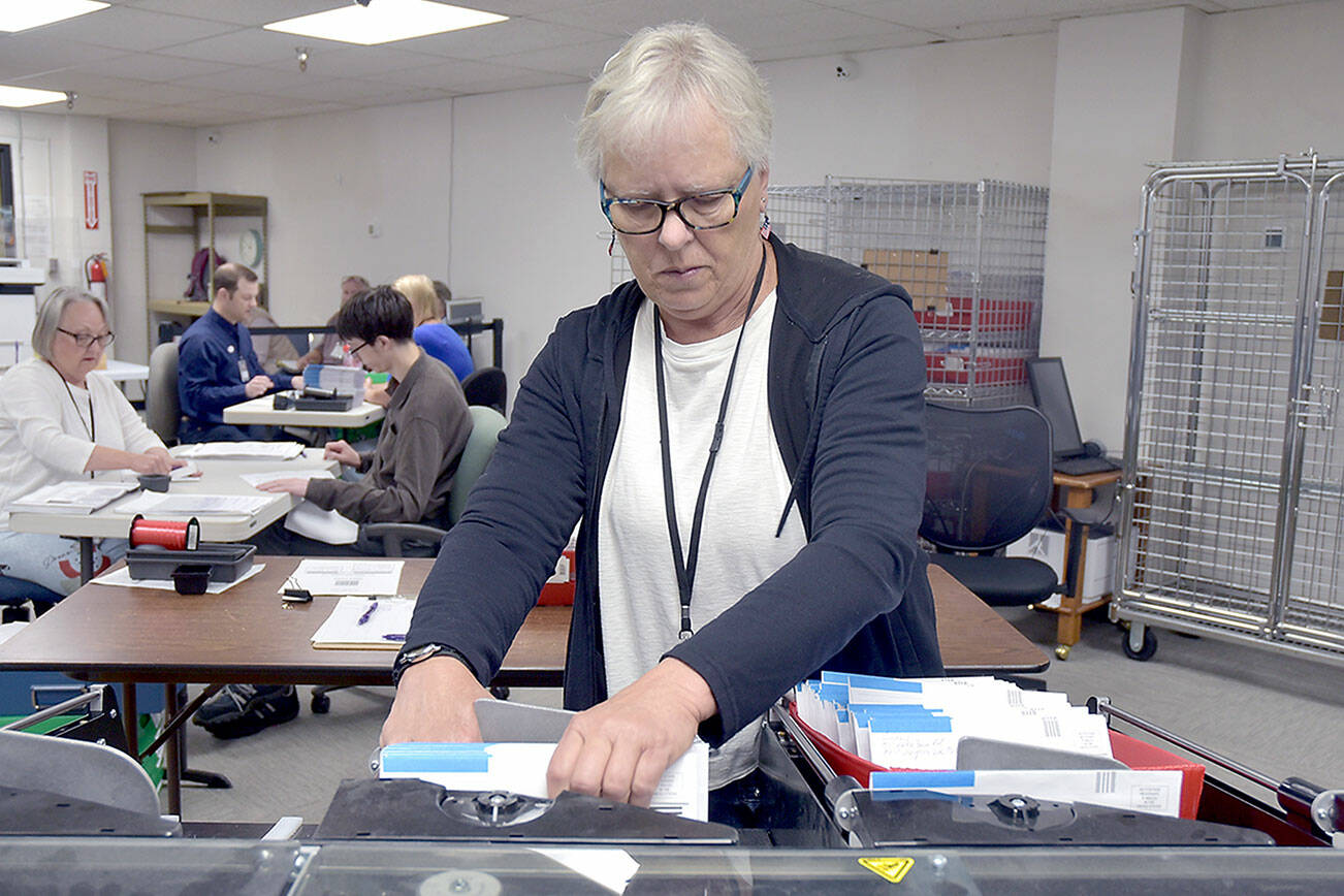 Clallam County election worker Janet Parris of Port Angeles sorts through incoming primary ballots on Tuesday at the Clallam County Courthouse. Initial results were scheduled to be released after print deadline. For election coverage, see Thursday’s print edition. (Keith Thorpe/Peninsula Daily News)