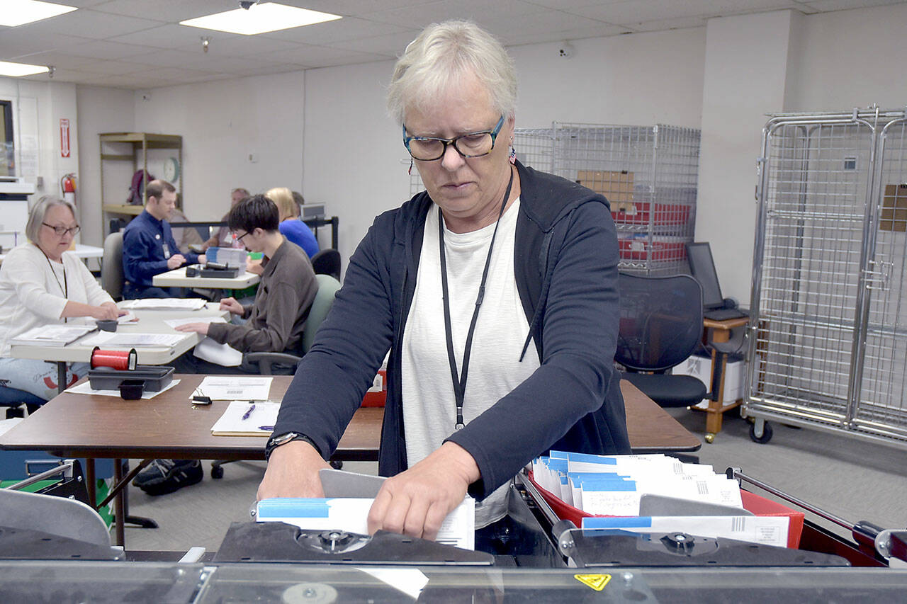 Clallam County election worker Janet Parris of Port Angeles sorts through incoming primary ballots on Tuesday at the Clallam County Courthouse. Initial results were scheduled to be released after print deadline. For election coverage, see Thursdays print edition. (Keith Thorpe/Peninsula Daily News)