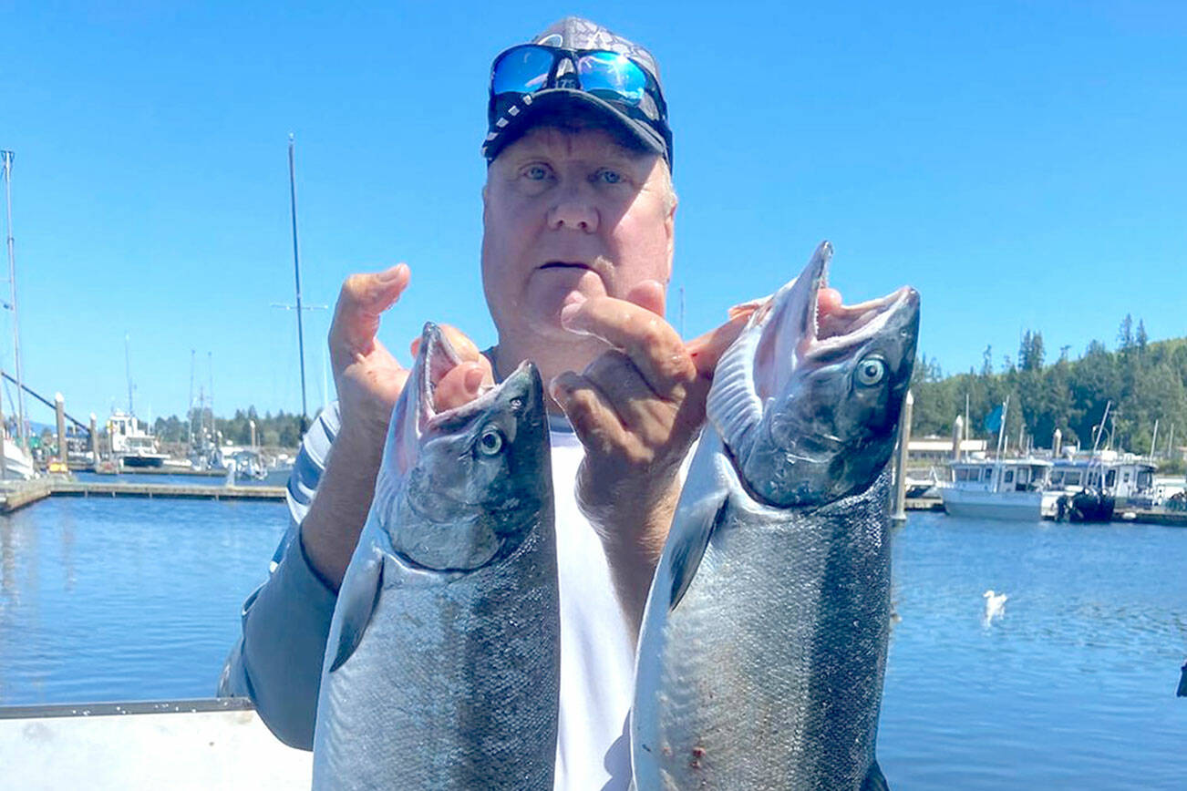 Yakima angler Terry Day brought home these two hatchery coho Sunday while fishing in the waters of Marine Area 4 (Neah Bay).