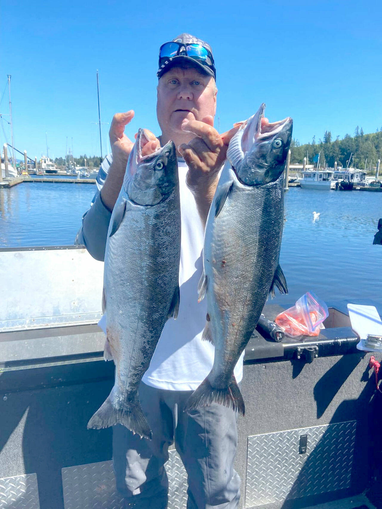 Yakima angler Terry Day brought home these two hatchery coho Sunday while fishing in the waters of Marine Area 4 (Neah Bay).