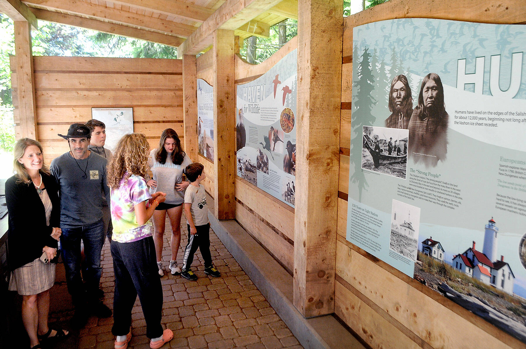 Members of the Polge family from Raleigh, N.C., from left, parents Tami and Steven, and siblings Sebastian, 18, Anna, 15, Christina, 18, and Nico, 7, examine an informational display at the Dungeness National Wildlife Refuge north of Sequim in June 2022. The refuge is sanctuary to a variety of Northwest wildlife and serves as the access point to the Dungeness Spit and the New Dungeness Lighthouse. (Keith Thorpe/Peninsula Daily News)