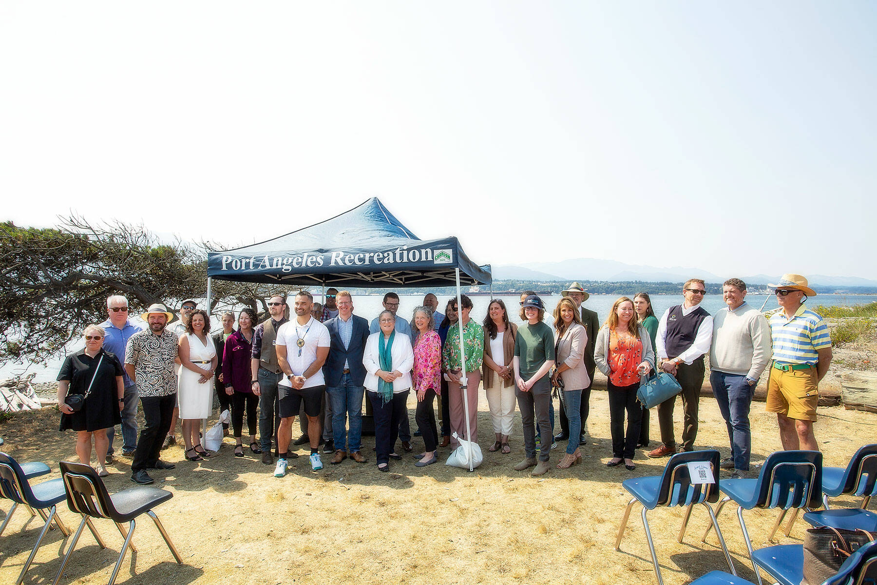 U.S. Rep. Derek Kilmer, D-Gig Harbor, and members of the North Olympic Peninsula Recompete Coalition stand together following a press conference at Harborview Park on Friday in Port Angeles. (Christopher Urquia/Peninsula Daily News)