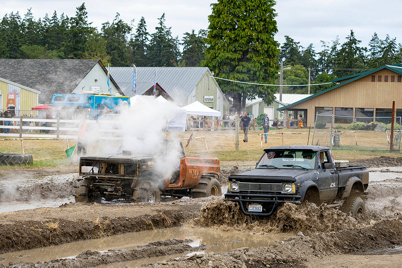 James Baker of Longview stalls out his nitrous oxide charged ‘76 Blazer in a race against Ethan Newman of Quilcene in his Chevy 350-powered 1980 Toyota pickup during the mud drags at the Jefferson County Fairgrounds on Sunday. (Steve Mullensky/for Peninsula Daily News)