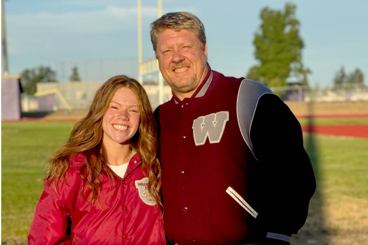 Sequim’s Riley Pyeatt with her high school coach Brad Moore at Sequim’s new track surface earlier this month. Pyeatt just signed a scholarship to run track and field for Washington State as both her and Moore are now proud Cougars. (Tracie Pyeatt)