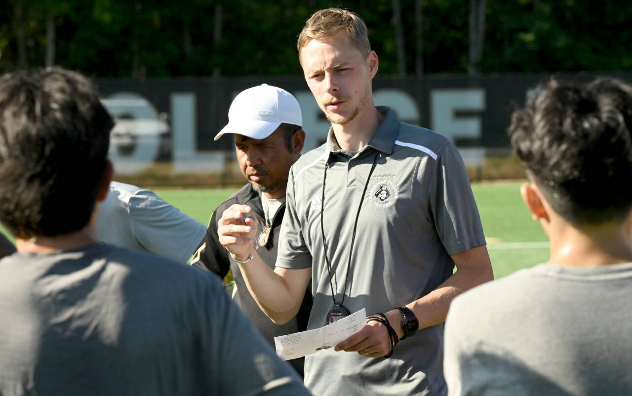 Head men's soccer coach Jake Hughes talks with his team during a practice at Wally Sigmar Field last week. The Pirates men and women are both ranked No. 1 in a preseason coaches' poll. (Peninsula College)