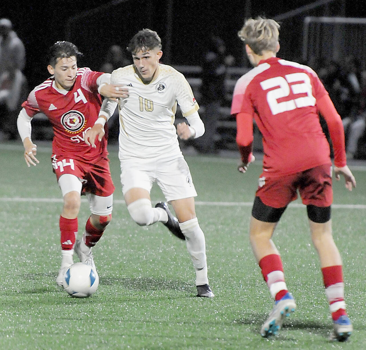 KEITH THORPE/PENINSULA DAILY NEWS Peninsula’s Nil Grau, center, fights off Skagit Valley’s Fernando Velazquez at Peninsula College’s Wally Sigmar Field last season. Grau, who scored eight goals last year for the Pirates, returns for his sophomore season this year.