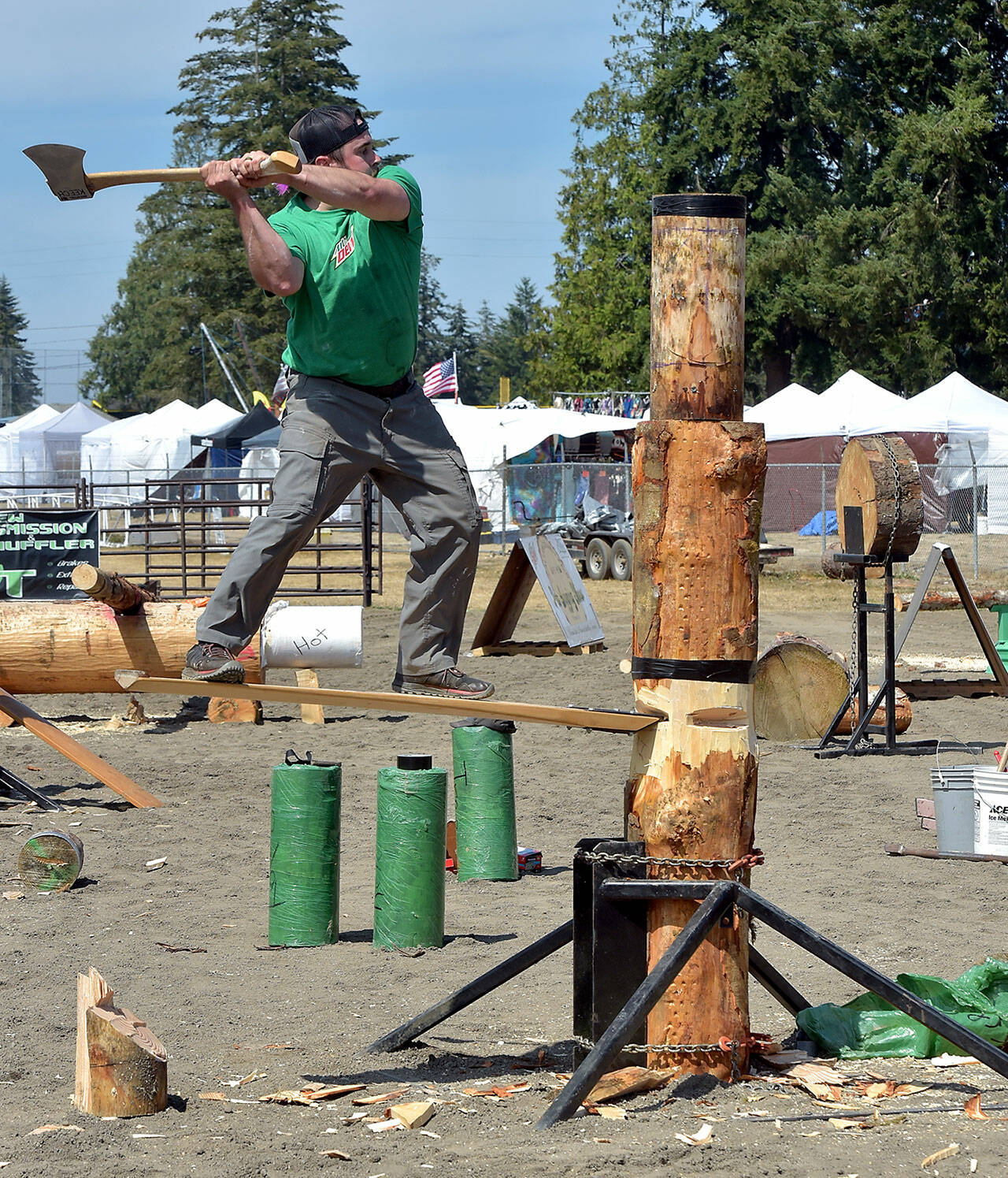 KEITH THORPE/PENINSULA DAILY NEWS Patrick Mahoney of Raymond takes aim at his wooden target during the springboard chop competition during Saturday’s logging show in the grandstands arena of the Clallam County Fair in Port Angeles. Mahoney went on to win the event against two other competetors.