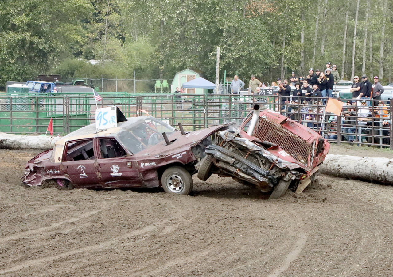 Ryan Petty, No. 95, crashes into Brandon Rutherford, lifting his car off the ground during the 2024 Demo Derby at the Clallam County Fair this weekend. (Dave Logan/for Peninsula Daily News)