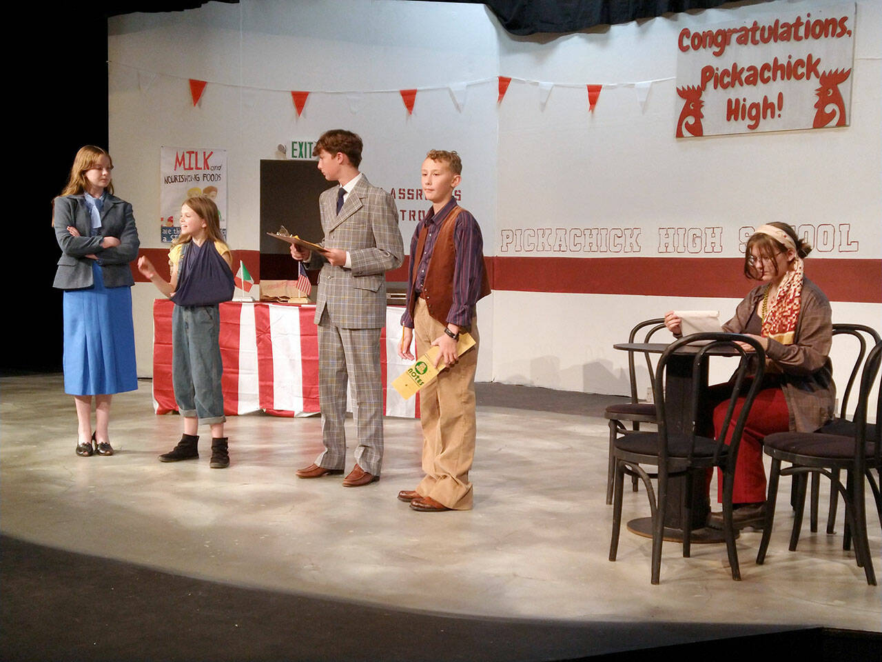 Principal Bonnie Bird (Aubrey Tanner) talks to Captain Curry (Matilda Redlin) and Rich Gravee (Henry Wendel) about the International Chicken Cooking Contest while reporters Burgundy Divan (Isaac Wendel) and Carla (Alivia Halverson) try to solve the murder of a famous chef in the Port Angeles Community Players’ Children’s Theater production of Murder Most Fowl this weekend. (Port Angeles Community Players)