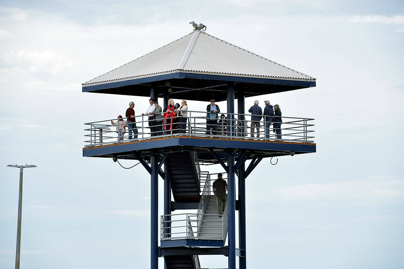 Visitors and dignitaries ascend the steps at the observation tower at Port Angeles City Pier on Wednesday after a ceremony to officially reopen the structure to the public. The tower was closed in November 2023 due to safety issues and structural concerns, prompting numerous repairs. Funding for the work, totaling more than $650,000, came from city lodging tax. (Keith Thorpe/Peninsula Daily News)