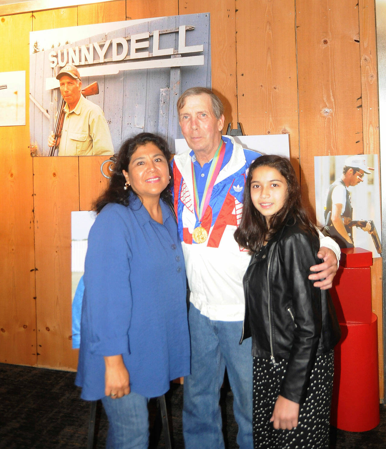 Matt Dryke, 1984 Olympic Games gold medal winner (skeet shooting), joins his wife Yvonne and daughter Ellen at the opening of the new Sequim Museum & Arts building in July 2019. A section of the museum details Dryke’s storied career in the sport. Sequim Gazette file photo by Michael Dashiell