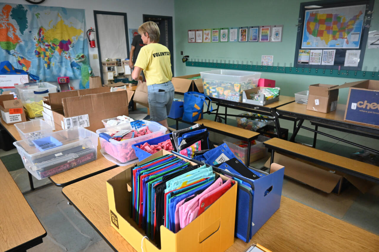 Kim Rosales and other volunteers help gather school supplies for students at last year’s Back to School Fair at the Sequim Boys & Girls Club. (Michael Dashiell/Olympic Peninsula News Group)