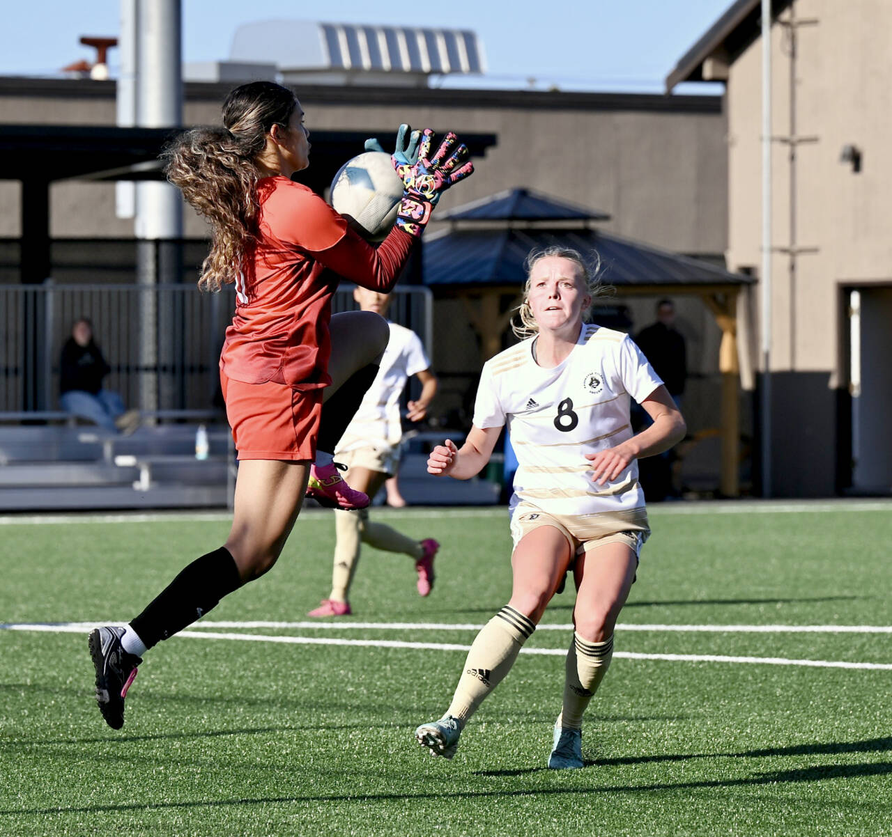 Peninsula College’s Anna Petty battles Multnomah University goalkeeper Jennifer Alvilar for control of the ball during Tuesday’s scrimmage at Walla Sigmar field in Port Angeles. (Jay Cline)