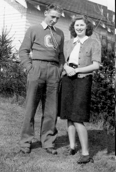 Ralph Henry Keil and Ginny Grimm in the front yard of the Keil home. Family members believe he is wearing his football sweater, with a “C” for Chimacum.