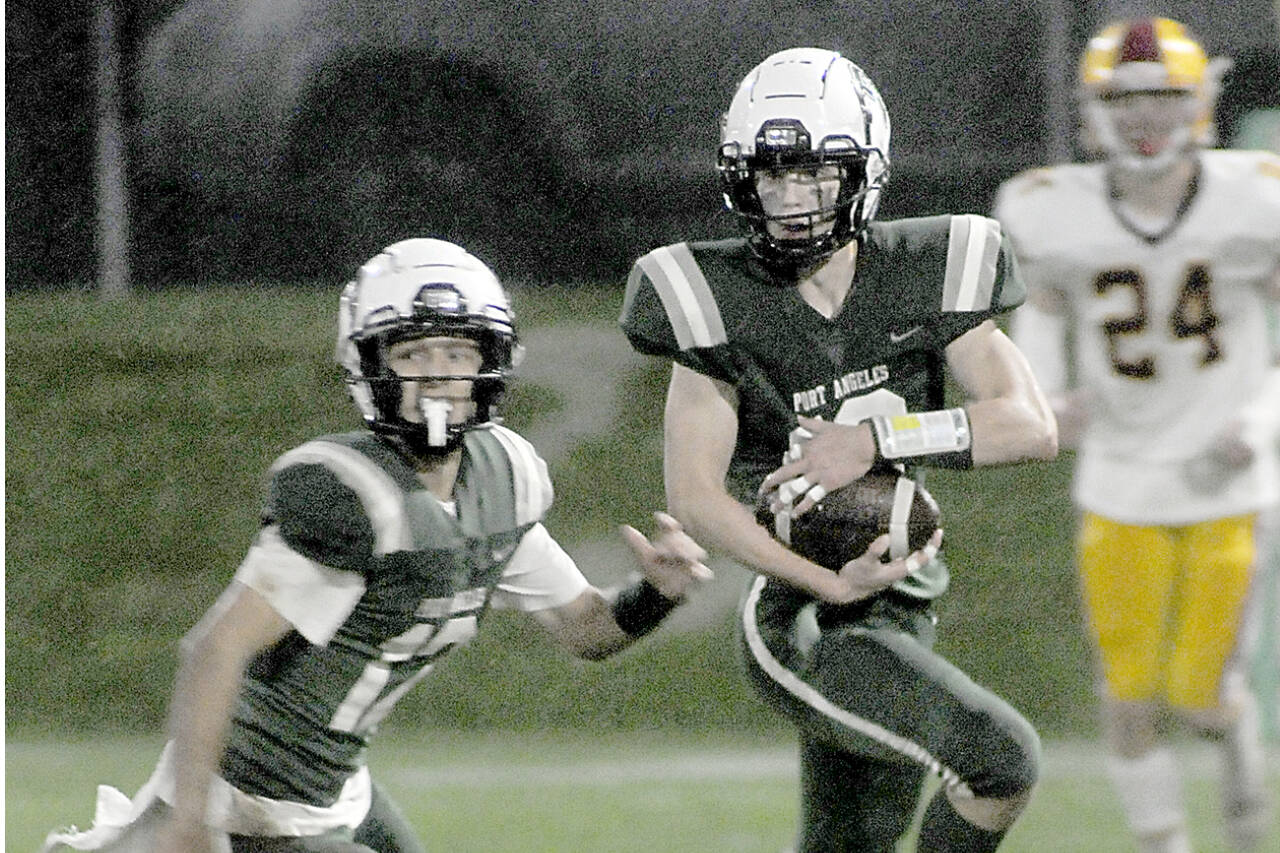 KEITH THORPE/PENINSULA DAILY NEWS
Port Angeles' Blake Sohlberg, right, is followed by teammate Kason Albaugh, leaving Kingston's Noah Walter far behind on Friday at Port Angeles Civic Field.