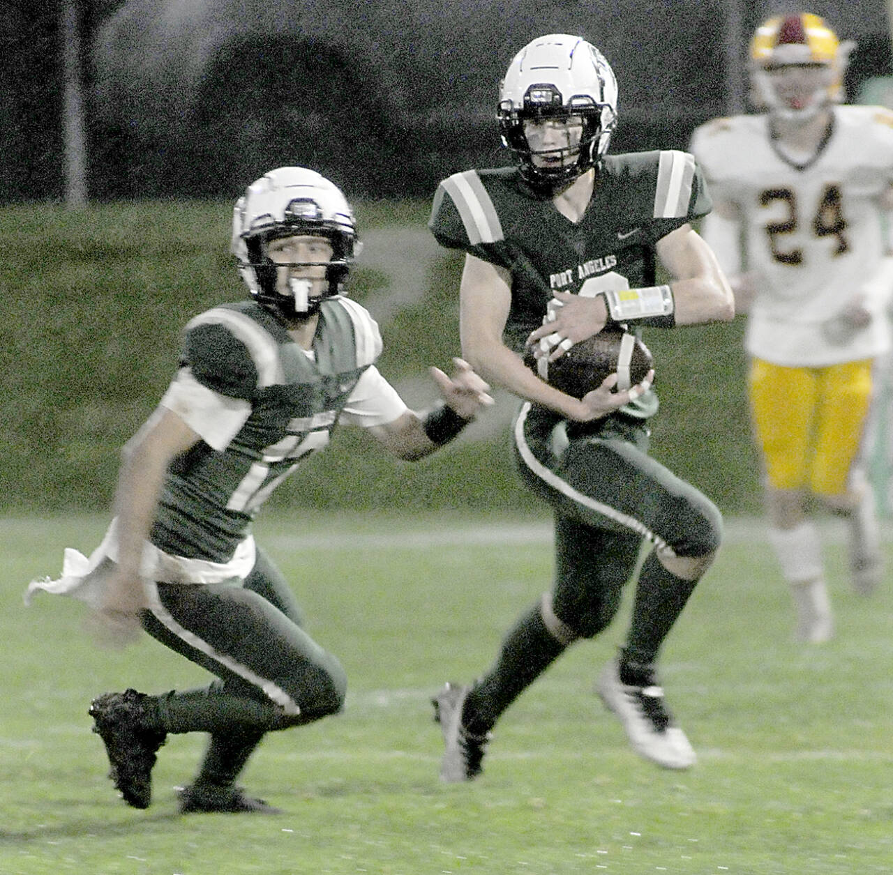 KEITH THORPE/PENINSULA DAILY NEWS Port Angeles’ Blake Sohlberg, right, is followed by teammate Kason Albaugh, leaving Kingston’s Noah Walter far behind on Friday at Port Angeles Civic Field.