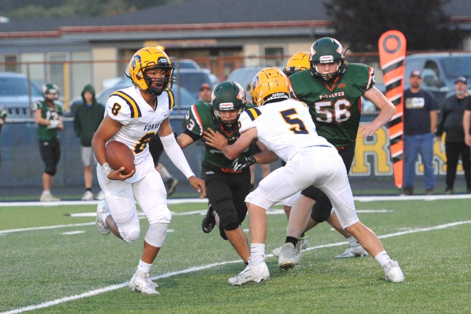 Forks quarterback Bubba Hernandez (8) runs the ball against Morton-White Pass in a 2023 game. Hernandez threw for 900 yards and rushed for 700 more and accounted for 24 total touchdowns in his freshman year. He returns this season to lead the Spartans’ offense. (Lonnie Archibald/for Peninsula Daily News)