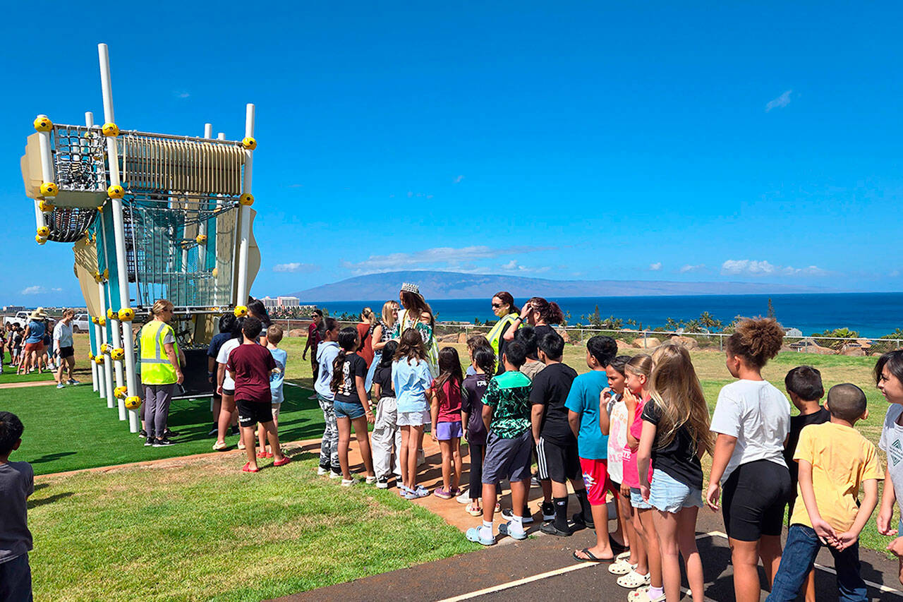 Hawaiian officials, students and staff celebrate the opening of new playground sets at King Kamehameha III Elementary School’s temporary site on Aug. 13. Sequim’s Danielle Patterson helped coordinate and donate the Wagga Wagga structure after wildfires in August 2023 destroyed the school. (Danielle Patterson/Allplay Systems)