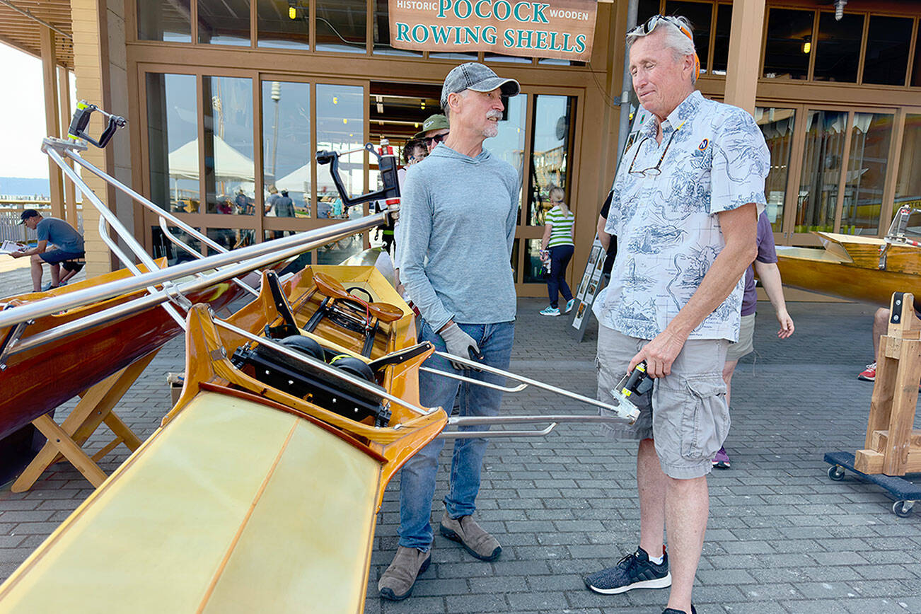 Steve Mullensky/ for Peninsula Daily News

Steve Chapin, left, and Devin Dwyer discuss the finer points of Dwyer’s 1980 standard cedar Pocock designed single scull. This scull and others are part of a display at the Wooden Boat Festival at Point Hudson Marina