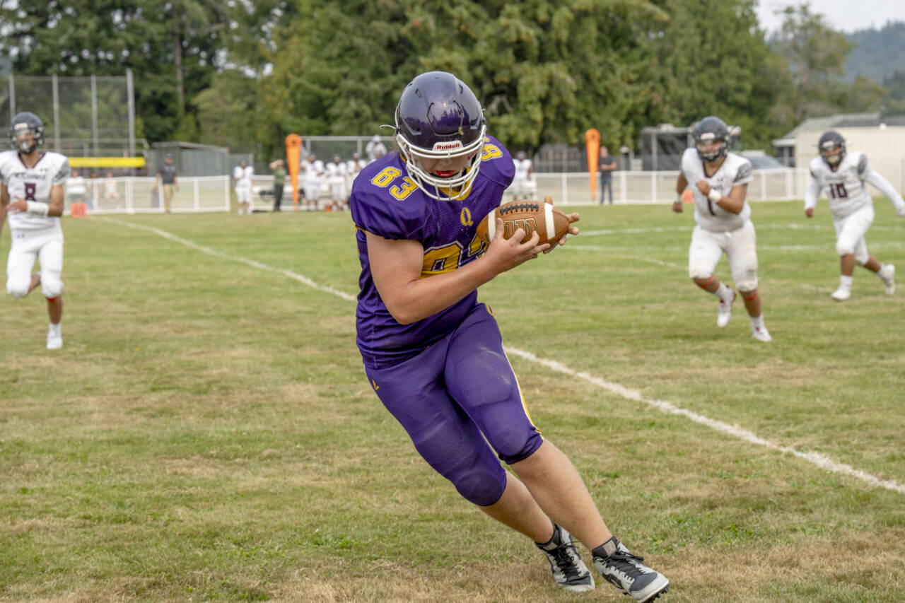 Quilcene receiver Taylor Boling taps both of his feet down on the sideline while making a catch against Lummi on Saturday. Quilcene won 38-18. (Steve Mullensky/for Peninsula Daily News)