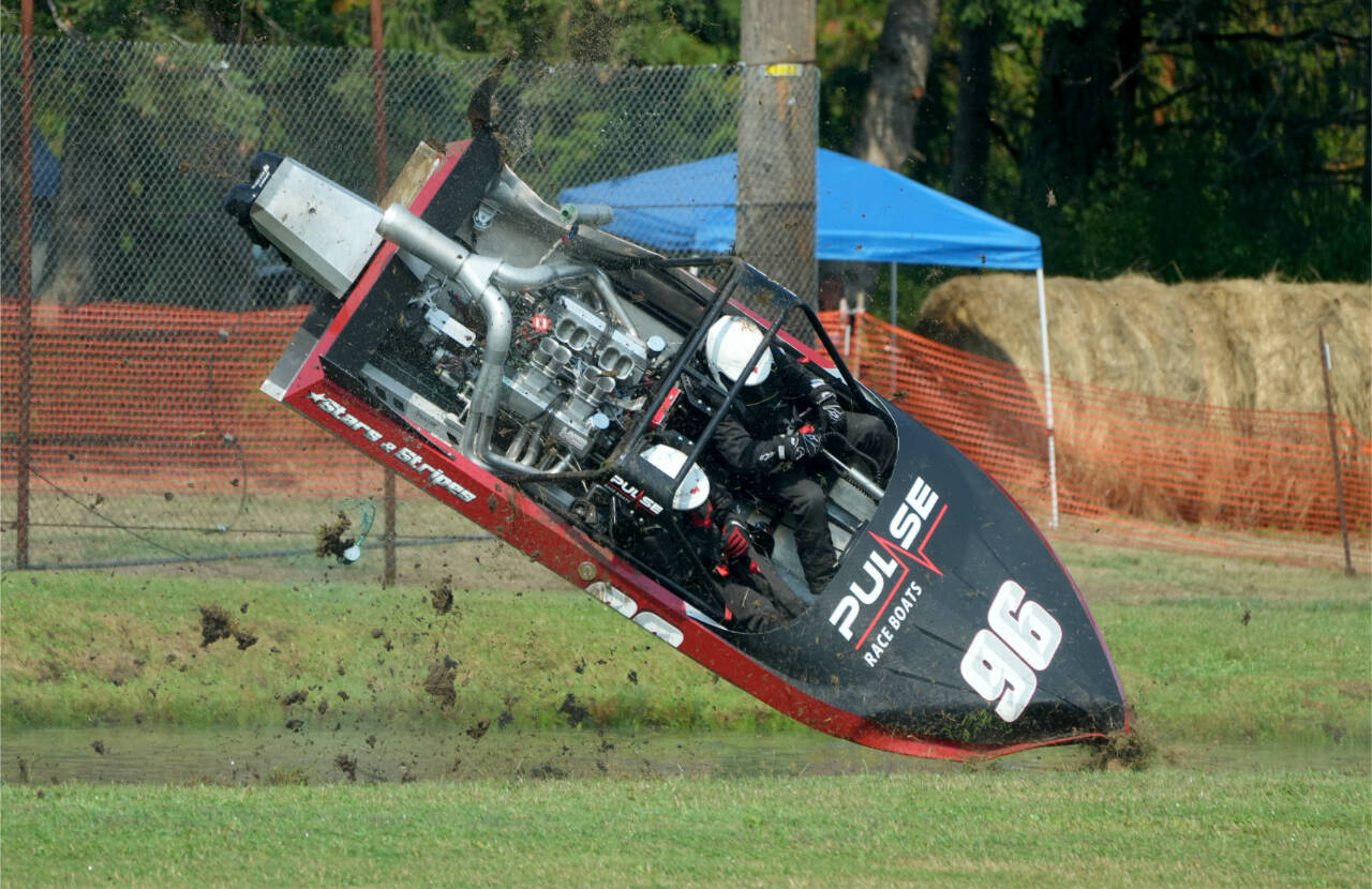 The Stars and Stripes Boat No. 96 driving by Burt Roberts and navigated by Luke Stewart, crashes out during the finals of the American Sprint Boat Racing quarterfinals Sunday at the Extreme Sports Park in Port Angeles. (Jeff Halstead/for Peninsula Daily News)