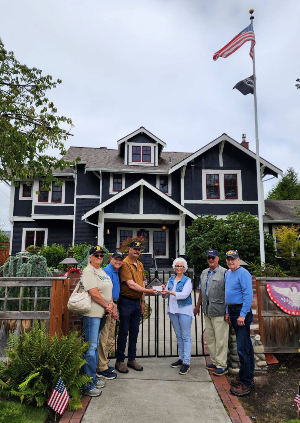 Carlsborg VFW Post 6787 representatives present a donation to the Captain Joseph House Foundation. Pictured, from left, are VFW representatives Denise Ashbran, Alan Morris and Commander Dave Yarnchak, Captain Joseph House founder Betsy Schultz, and VFW representatives Gary Vetie and Tom Cox. (Claire Rausch)