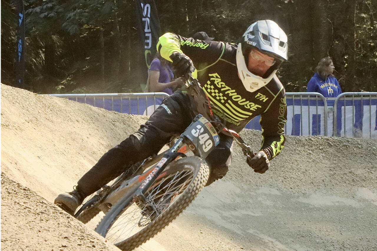 Sean Salliotte of Medford, Ore., 52, takes the final banked curve before the finish line at the NW Cup downhill races Sunday. takes the last banked curve before the finish line. (Dave Logan/for Peninsula Daily News)