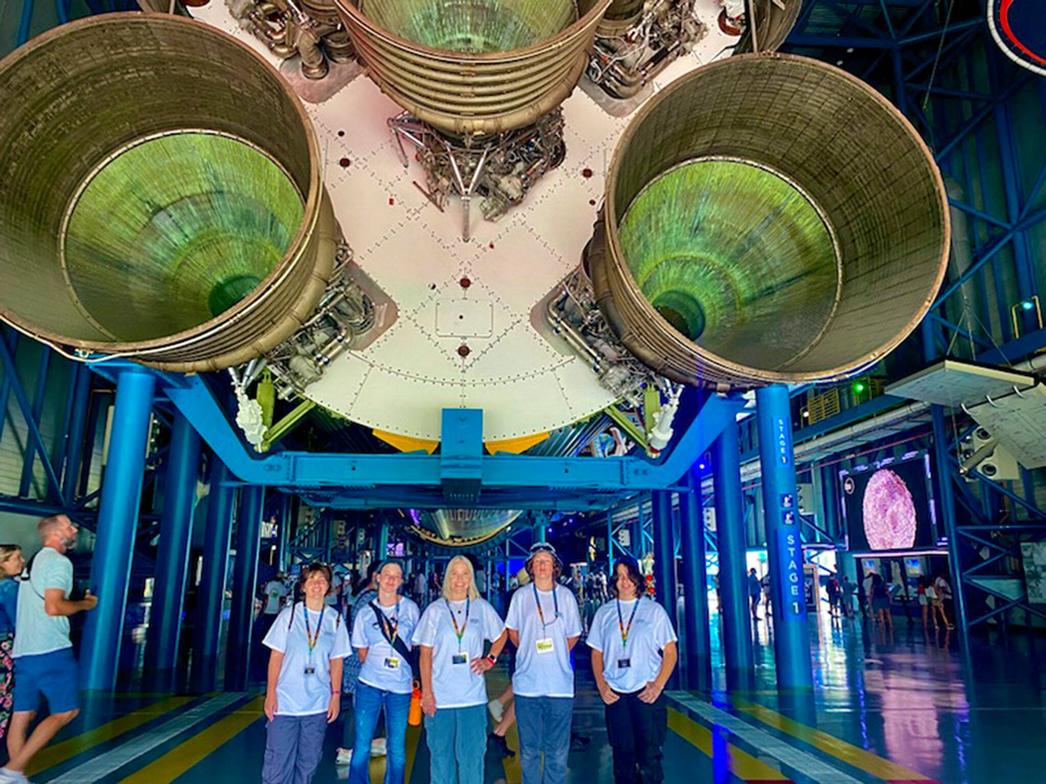 Standing below the Saturn V rocket, Sequim students and teacher, from left, Megan Reeves, Allee Deering, Sara Turner, Riley Guimond and Olivia Lozano enjoy a tour of the Kennedy Space Center Visitor Complex after they won a trip to Florida through their Sequim Middle School club. (Sara Turner)