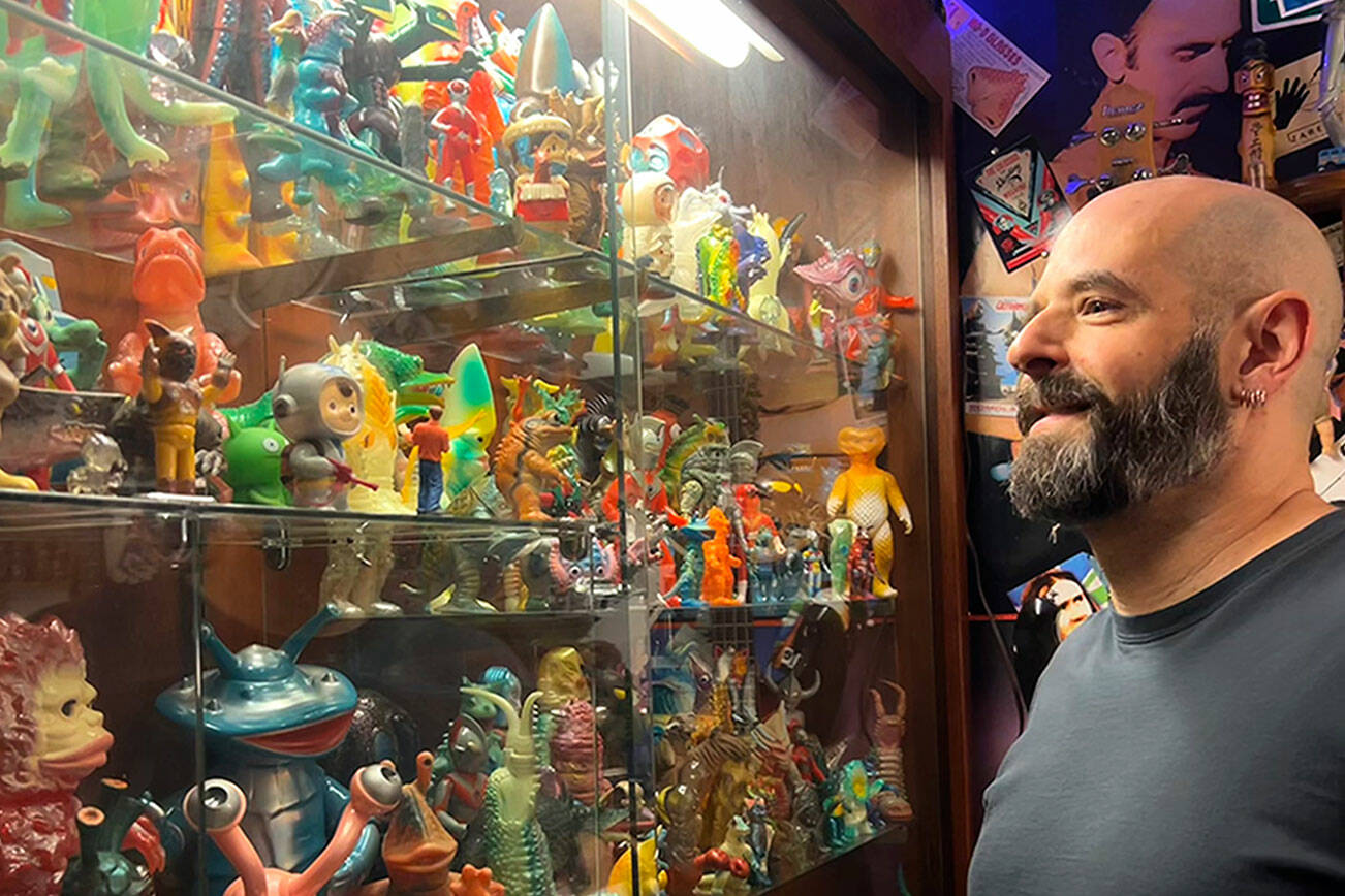 Corey Edwards, organizer of the Olympic Peninsula Toy and Collectibles Show, stands by his case of Kaiju monsters he’s been collecting since the early 2000s. He said the show on Saturday will be an option for locals to find new and old toys that they might remember from their childhood. (Matthew Nash/Olympic Peninsula News Group)