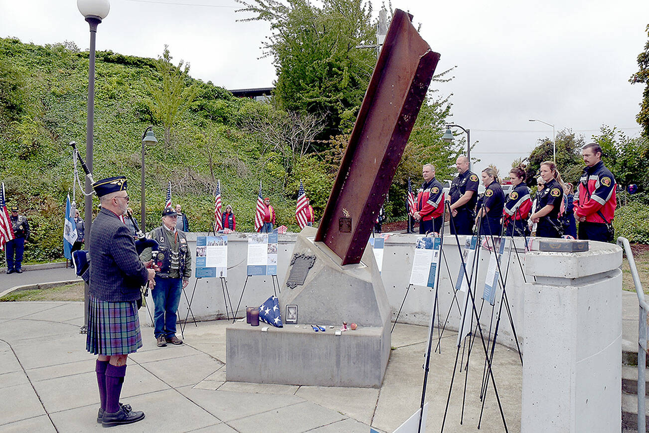 Rick McKenzie, a retired Coast Guard veteran, plays bagpipes at the 9/11 memorial at the Francis Street Park in Port Angeles on Wednesday. (Keith Thorpe/Peninsula Daily News)