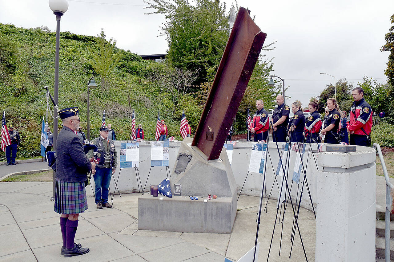 Rick McKenzie, a retired Coast Guard veteran, plays bagpipes at the 9/11 memorial at the Francis Street Park in Port Angeles on Wednesday. (Keith Thorpe/Peninsula Daily News)