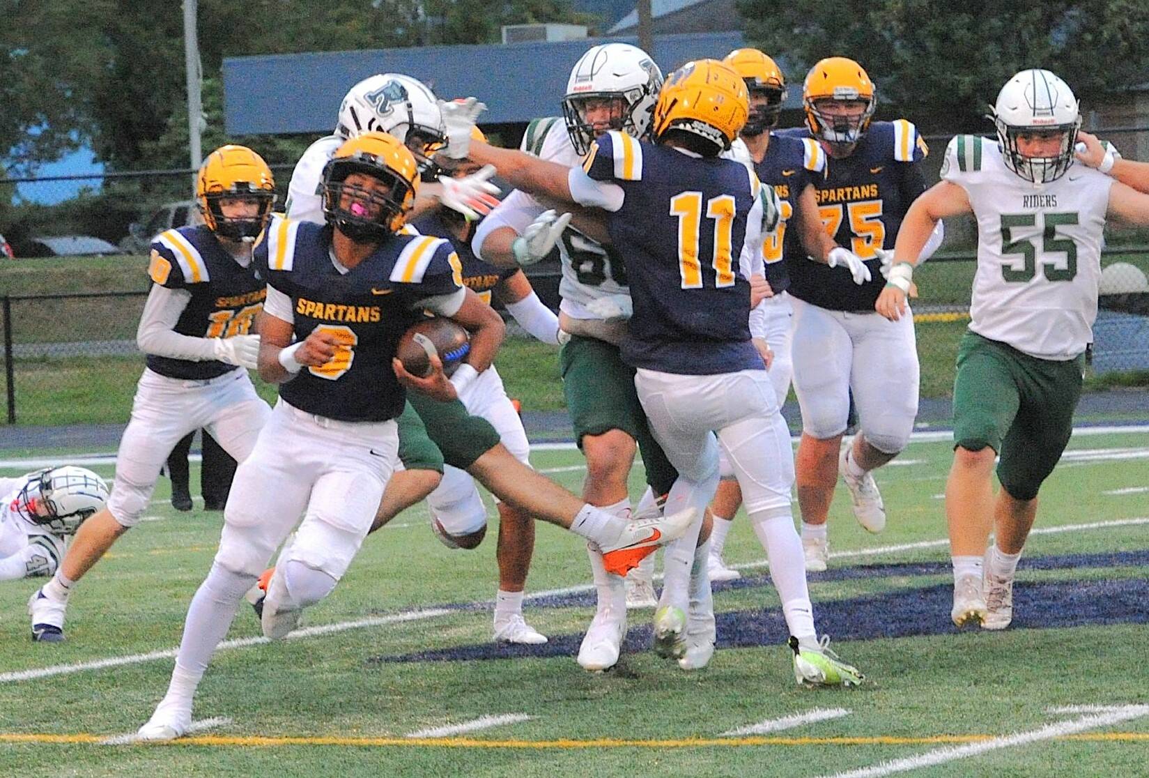 Bubba Hernandez-Stansbury somehow breaks out of a mass of tacklers and sprints for a 57-yard touchdown against Port Angeles on Friday night. Forks won a defensive battle 13-7. (Lonnie Archibald/for Peninsula Daily News)