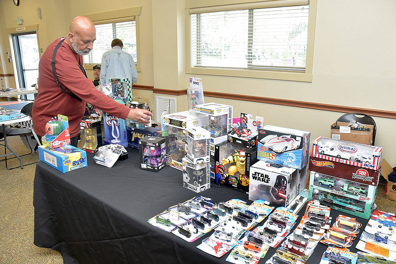 Paulo Leite of Port Angeles sets up a display of automotive and Star Wars toys at Saturday’s Olympic Peninsula Toy and Collectibles Show at Guy Cole Convention Center in Sequim. The exhibition featured a wide variety of toys and collectible items for display, sale or trade. (Keith Thorpe/Peninsula Daily News)