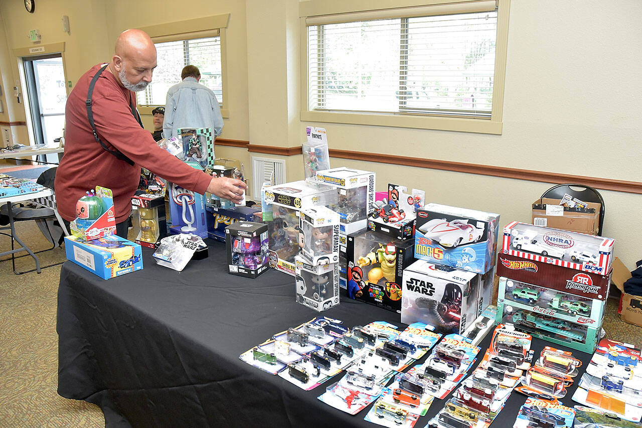 Paulo Leite of Port Angeles sets up a display of automotive and Star Wars toys at Saturday’s Olympic Peninsula Toy and Collectibles Show at Guy Cole Convention Center in Sequim. The exhibition featured a wide variety of toys and collectible items for display, sale or trade. (Keith Thorpe/Peninsula Daily News)