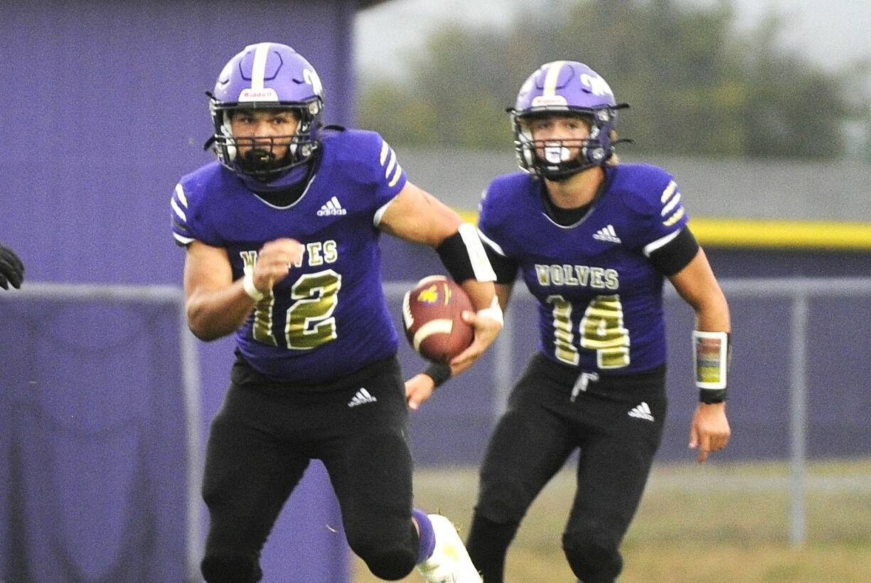 Sequim's Liam Wiker (No. 12) runs the ball against Franklin Pierce. In the background is Zeke Schmadeke (No. 14). Michael Dashiell/Olympic Peninsula News Group.