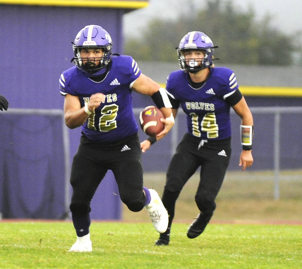 Sequim’s Liam Wiker (No. 12) runs the ball against Franklin Pierce. In the background is Zeke Schmadeke (No. 14). (Michael Dashiell/Olympic Peninsula News Group.)