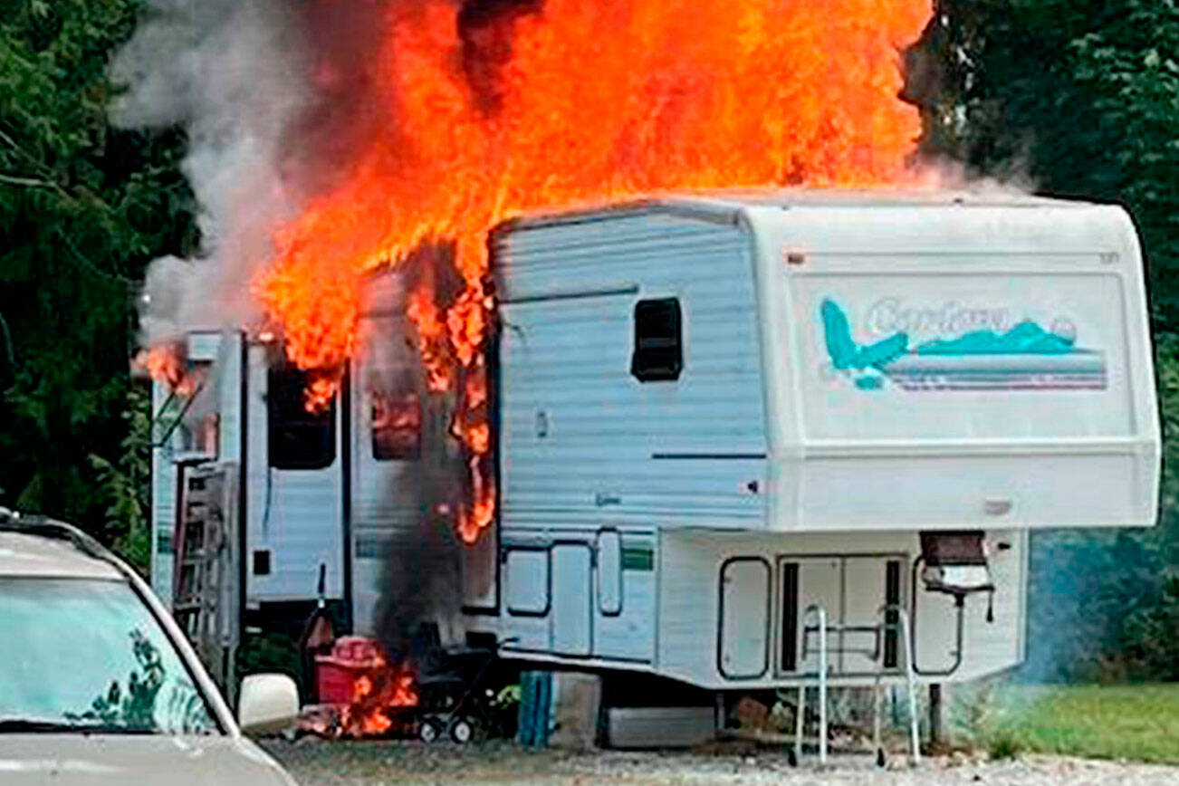 One person was airlifted to Harborview Medical Center in Seattle after a fifth-wheel trailer was fully engulfed in flames on Friday. (Chris Turner/Clallam County Fire District 3)