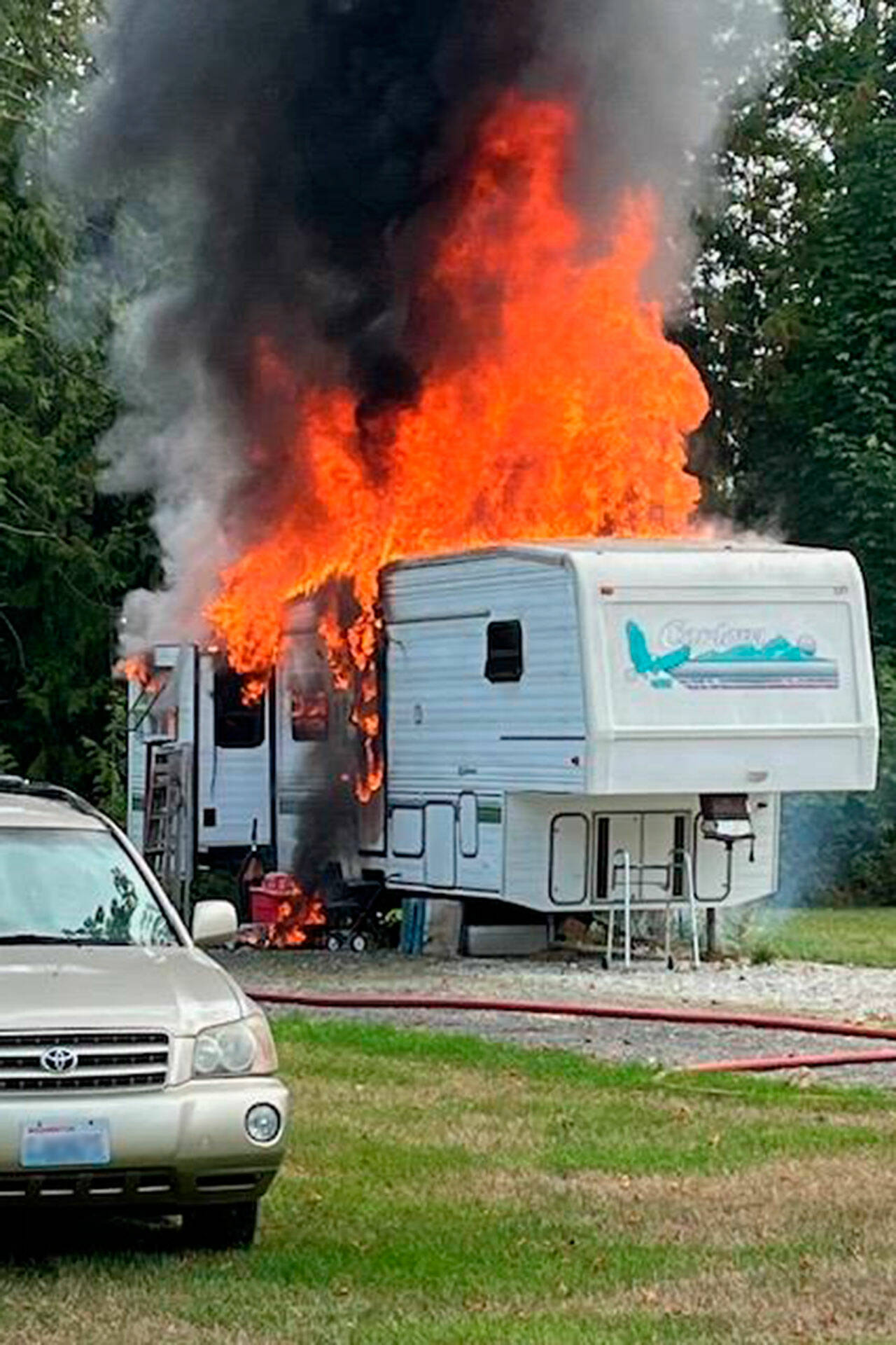 One person was airlifted to Harborview Medical Center in Seattle after a fifth-wheel trailer was fully engulfed in flames on Friday. (Chris Turner/Clallam County Fire District 3)