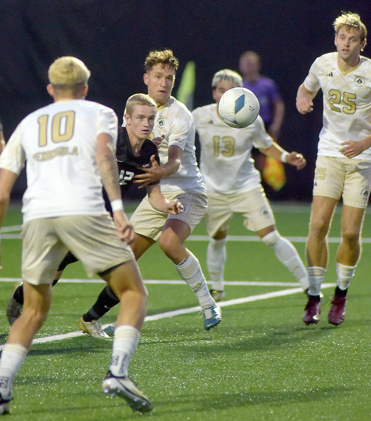 KEITH THORPE/PENINSULA DAILY NEWS Everett’s Lunden Fenster, second from left, eyes a loose ball surrounded by Peninsula’s (from left) Nil Grau, Konrad Mueller, Ezrrah Ochoa, and Sid Gunton-Day on Wednesday night in Port Angeles.