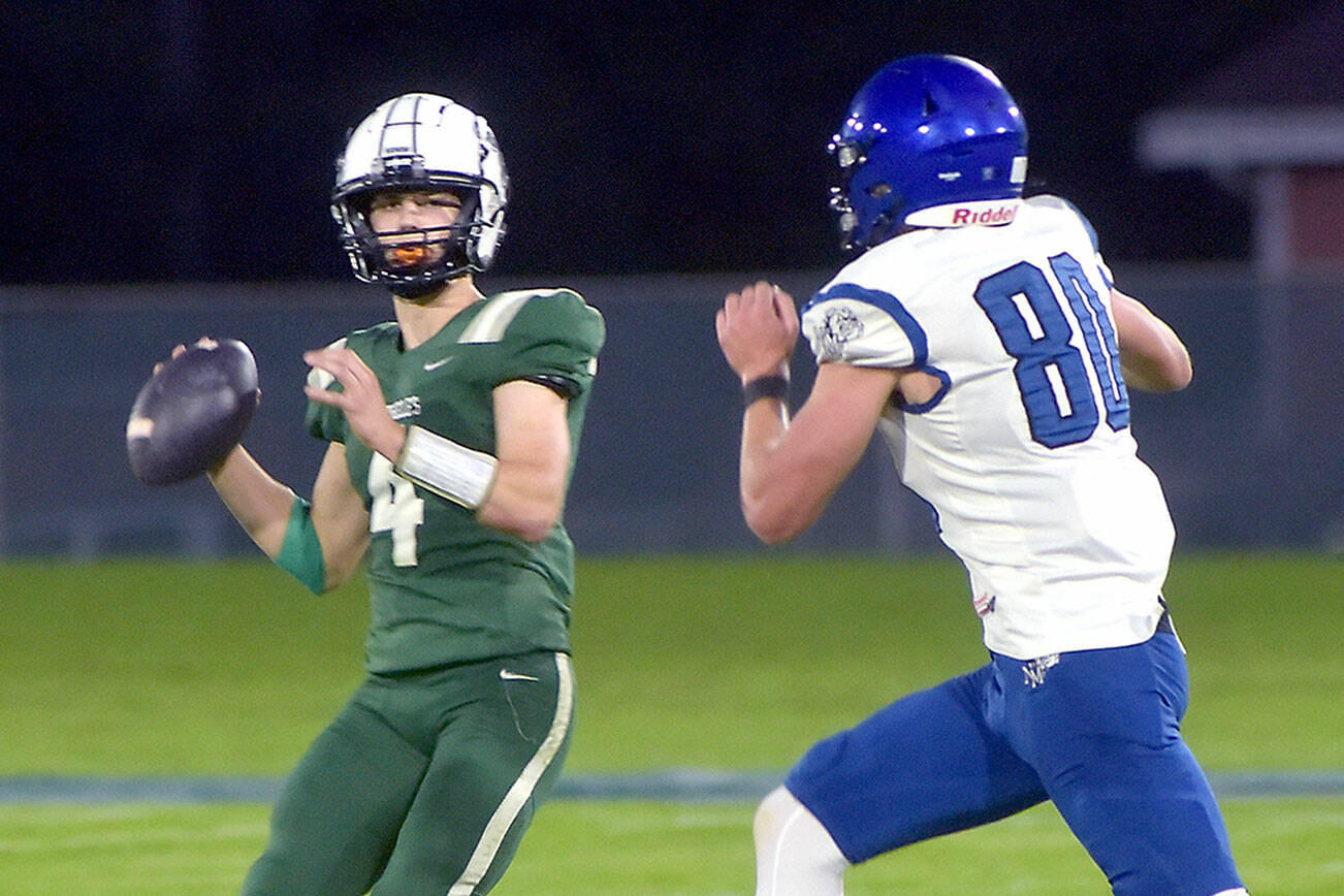 KEITH THORPE/PENINSULA DAILY NEWS
Port Angeles quarterback Blake Sohlberg looks to pass as North Mason's Derek Dunham on Friday in Port Angeles.