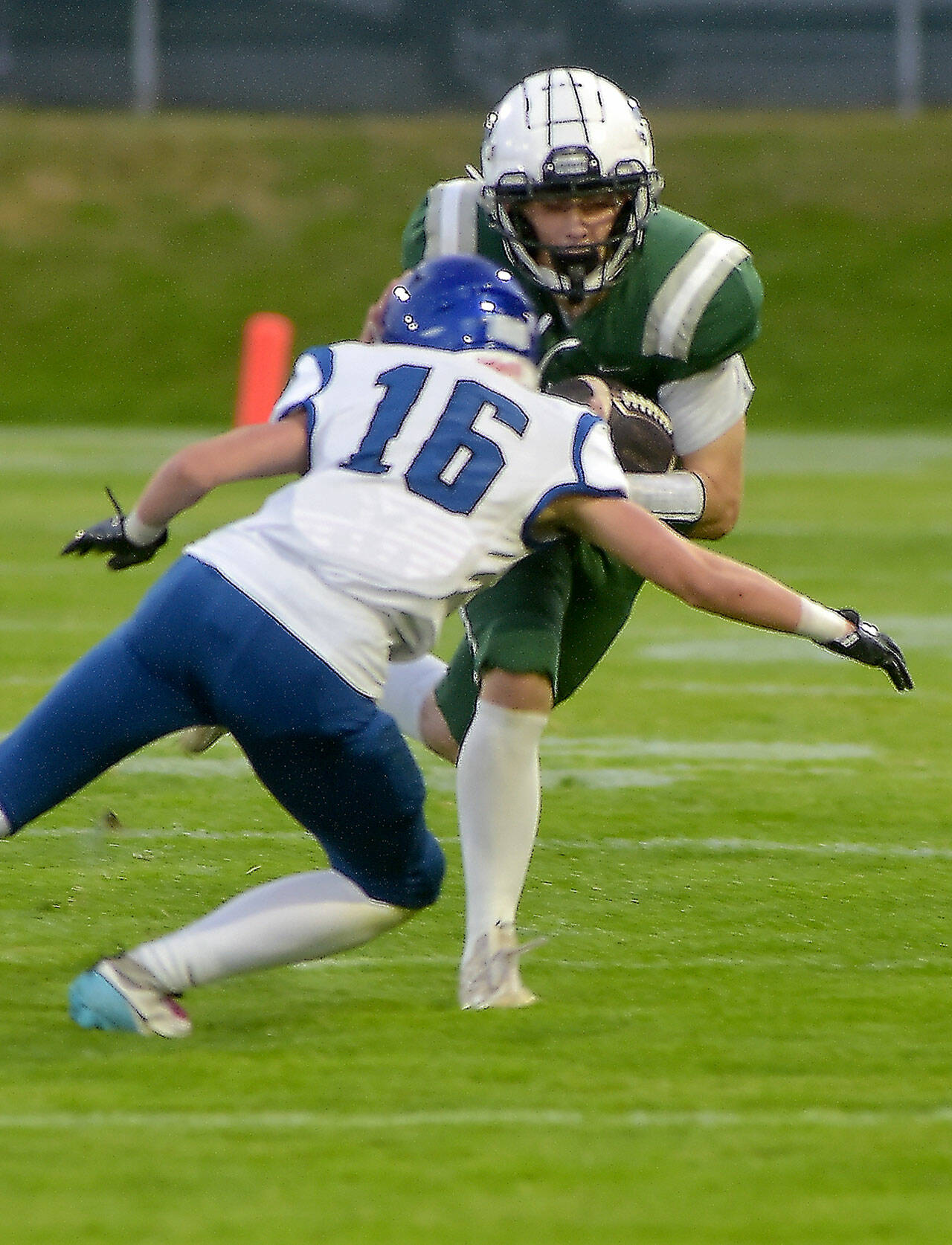 KEITH THORPE/PENINSULA DAILY NEWS Port Angeles’ Ricky Peterson tries to evade North Mason’s Chris Arbogast on Friday night at Port Angeles Civic Field.