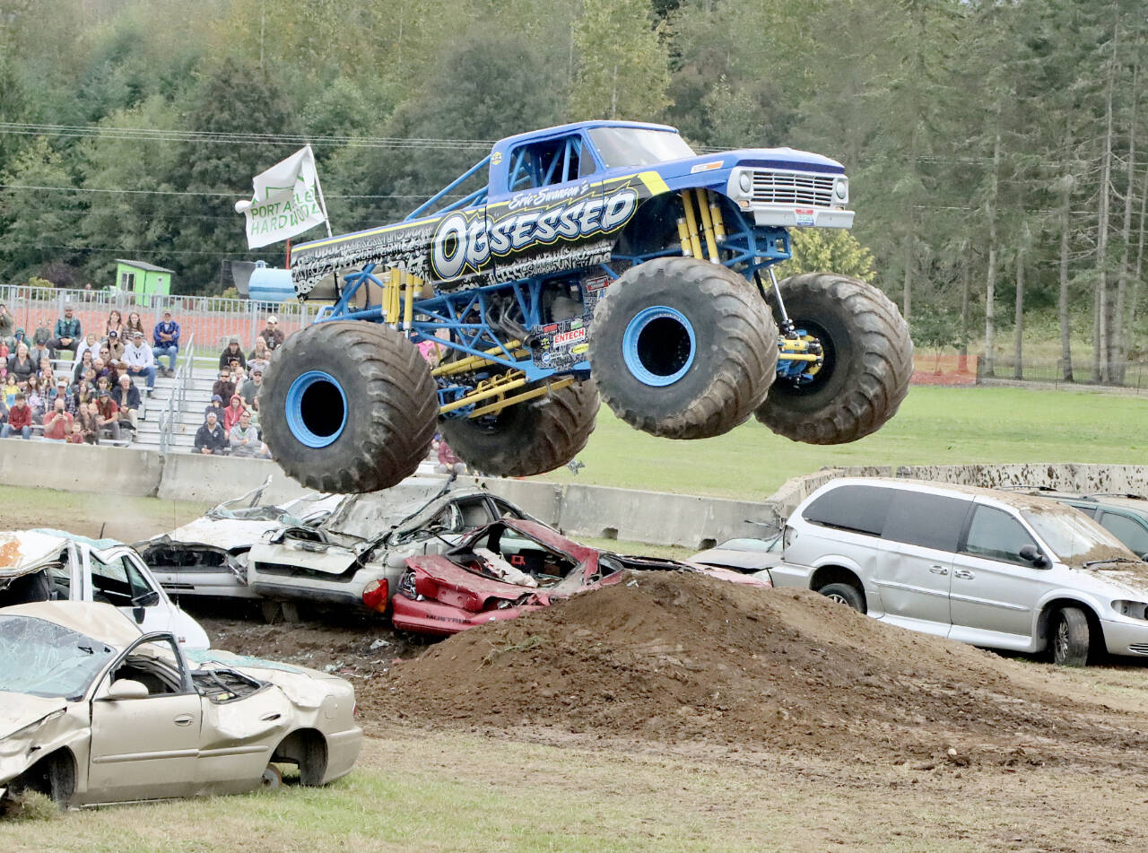 At the Fall Fest at the Extreme Sports Park west of Port Angeles, monster trucks ruled the day Sunday. Eric Swanson’s monster truck "Obsessed" flies over the jump to the delight of the crowd. (Dave Logan/for Peninsula Daily News)