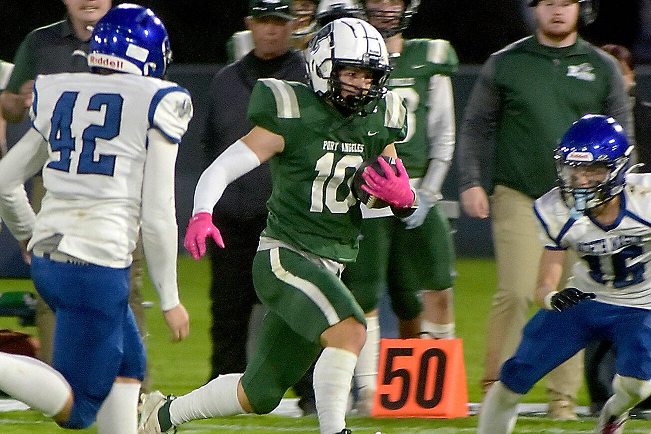 Port Angeles’ Ian Smiythson, center, slips past the defense of North Mason’s Robert Hickerson, left, and Chris Arbogast during Friday night’s game at Port Angeles Civic Field. (Keith Thorpe/Peninsula Daily News)