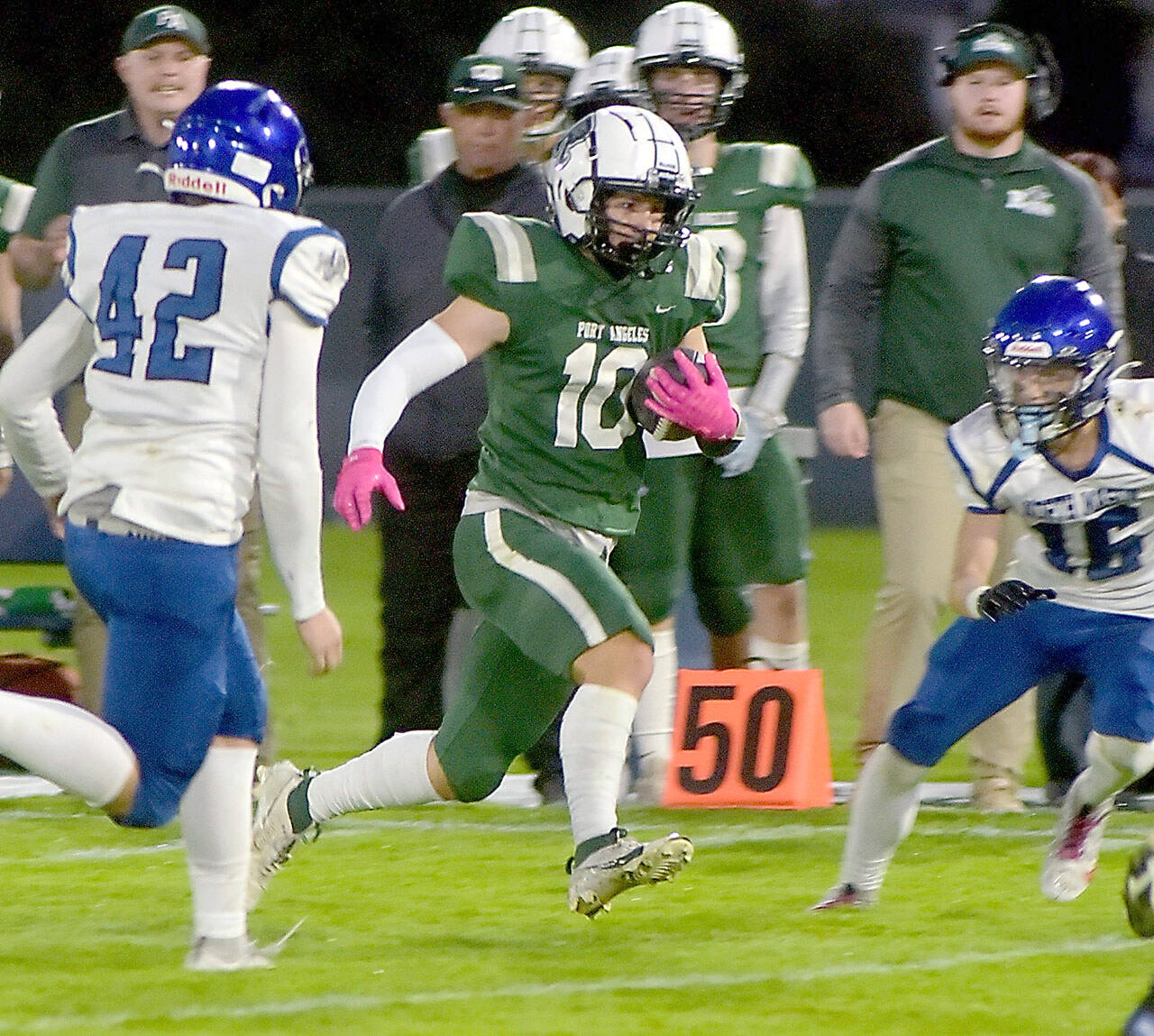 Port Angeles’ Ian Smiythson, center, slips past the defense of North Mason’s Robert Hickerson, left, and Chris Arbogast during Friday night’s game at Port Angeles Civic Field. (Keith Thorpe/Peninsula Daily News)