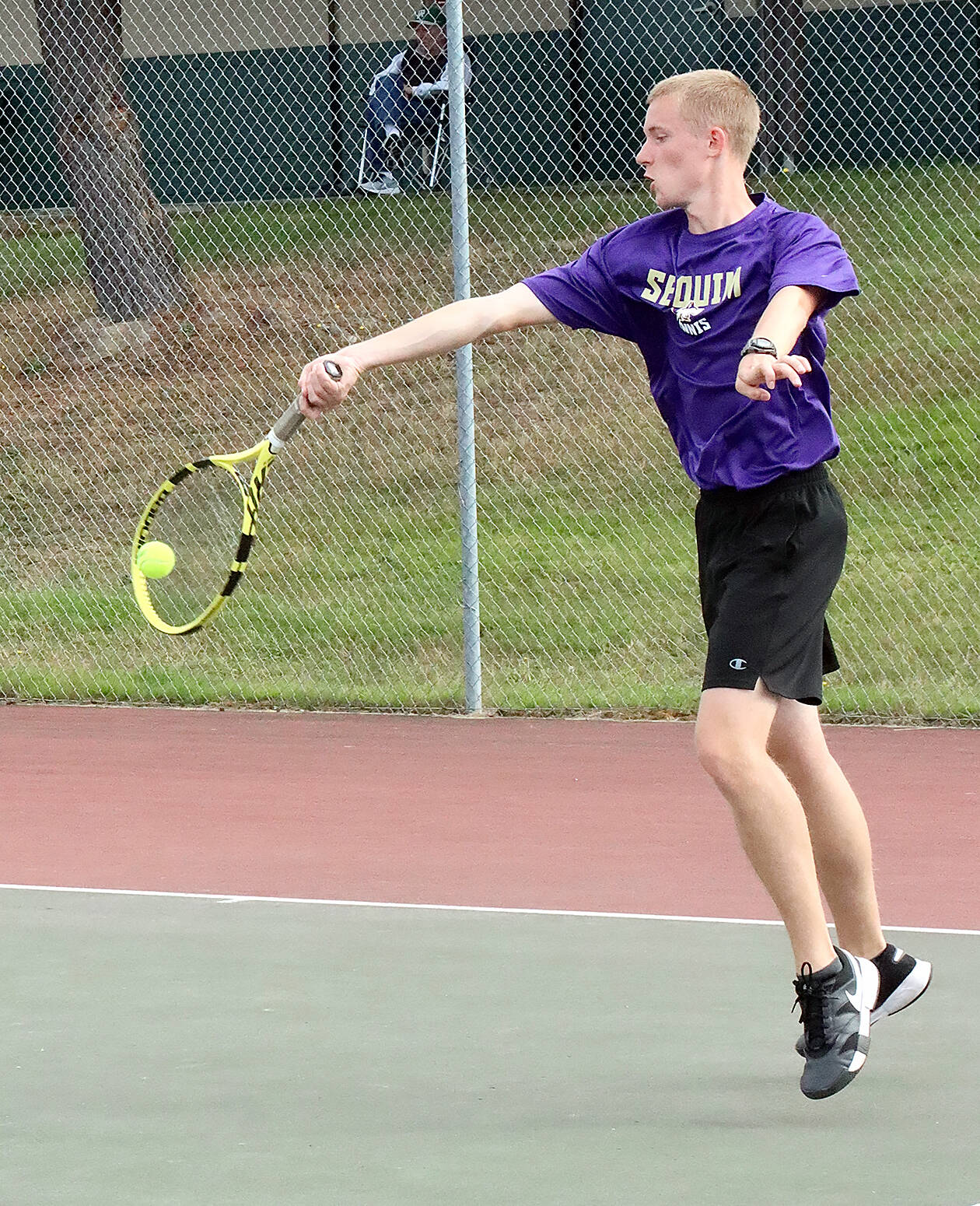 Photos by Dave Logan/for Peninsula Daily News
Sequim’s No. 1 singles player Jack Crecelius returns a volley against Port Angeles’ Tate Alton.