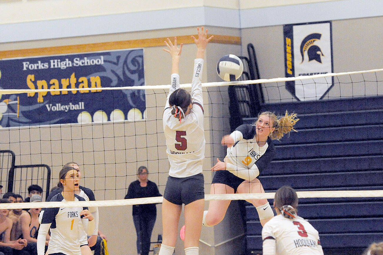 Spartan Keana Rowley gets the hit against Hoquiam's Hayden Brook-Andrew Tuesday night in Forks where Forks outlasted the Grizzlies winning 3 to 2 in all close sets.  Also in the action are Forks' Erika Williams (1) and Hoquiams's Katlyn Brodhead (3). Photo by Lonnie Archibald.