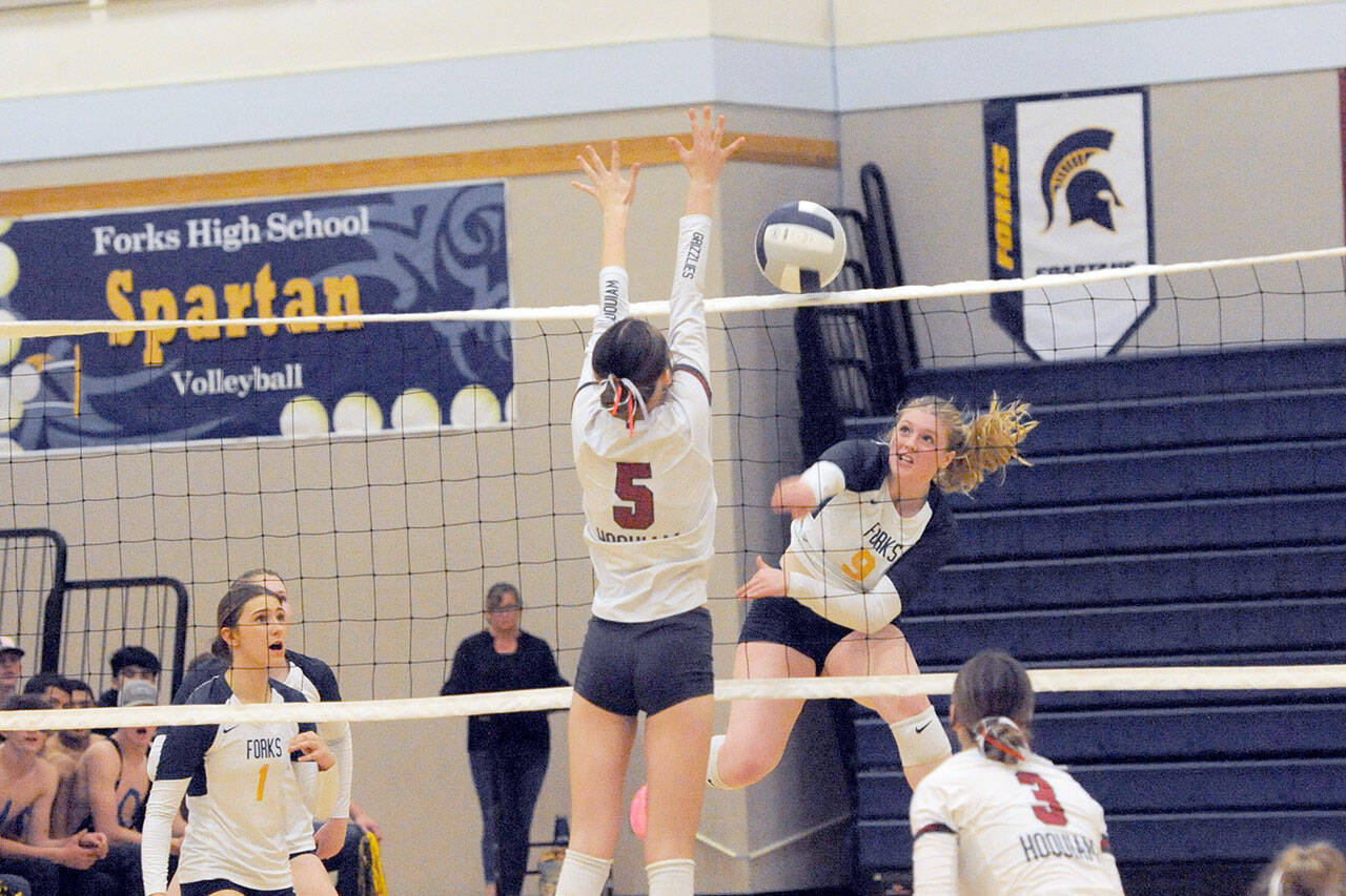 Forks’ Keana Rowley gets the hit against Hoquiam’s Hayden Brook-Andrew Tuesday night in Forks. The Spartans outlasted the Grizzlies 3-2 in a 212-point match.. Also in the action are Forks’ Erika Williams (1) and Hoquiams’s Katlyn Brodhead (3). (Lonnie Archibald/for Peninsula Daily News)