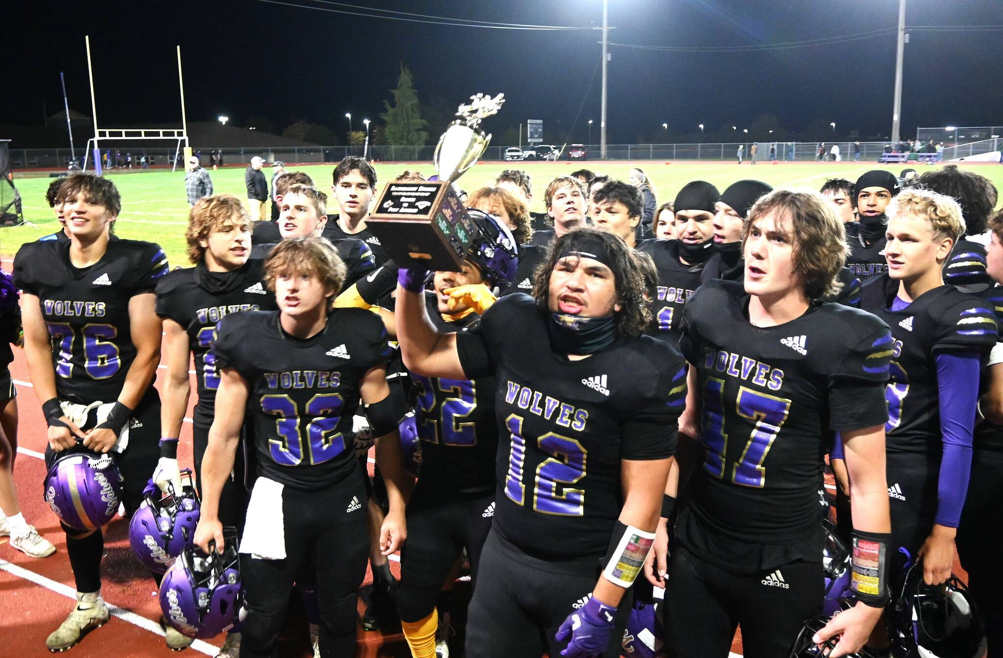 The Sequim Wolves celebrate winning the Rainshadow Rumble trophy in Sequim on Friday night. Sequim beat Port Angeles 27-7. (Michael Dashiell/Olympic Peninsula News Group)